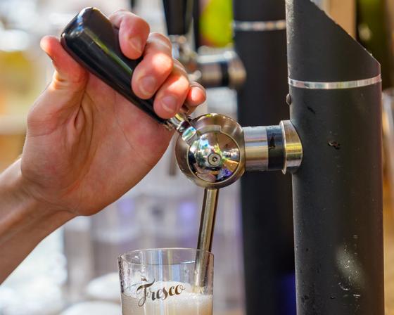 Pouring a beer into a Mr. Fresco glass