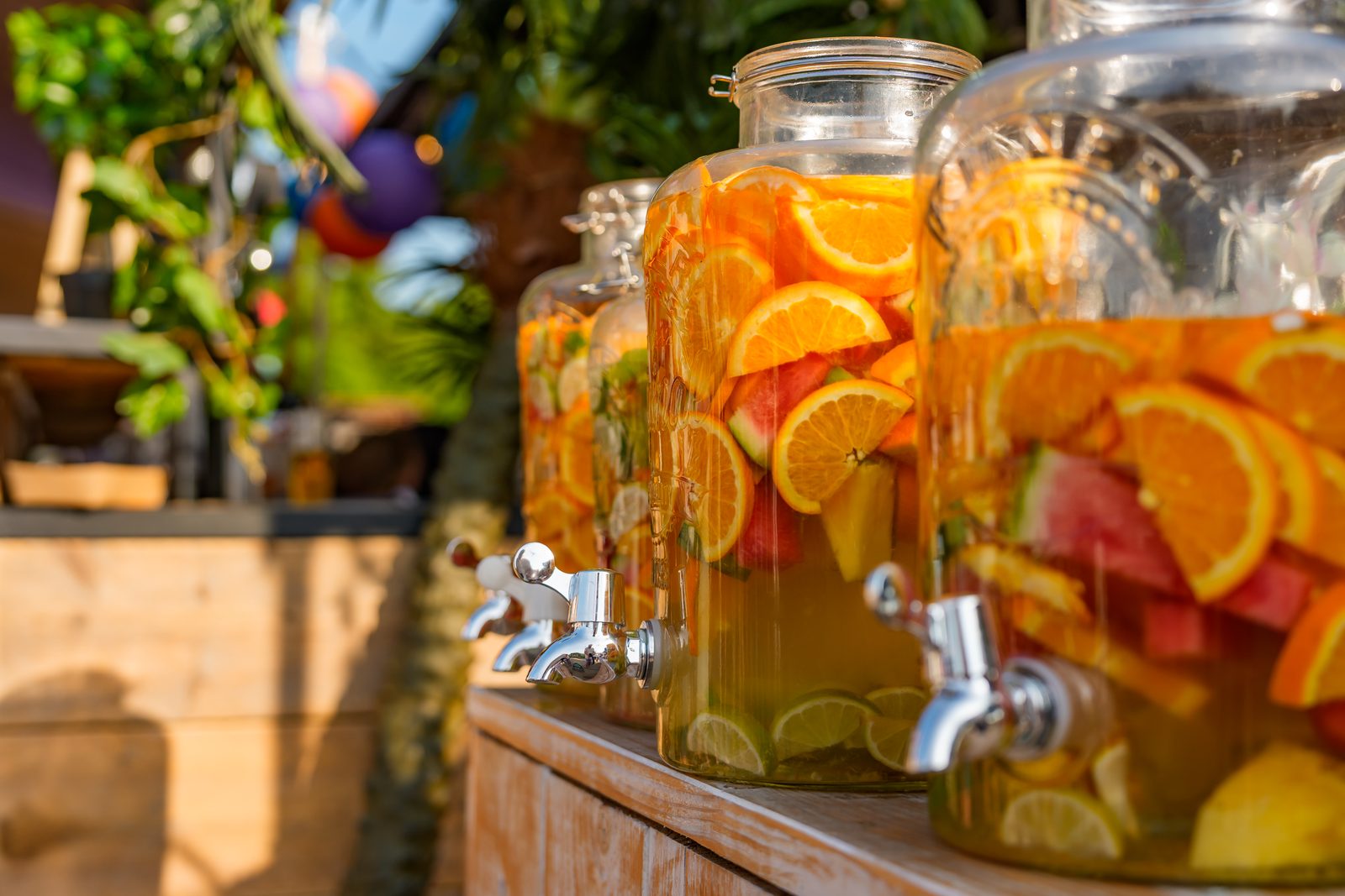 Glass dispensers with water, orange, watermelon and lime